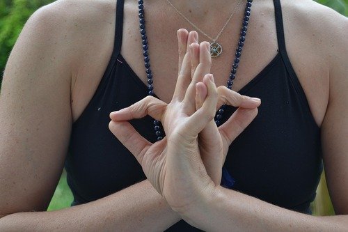 Les mains d'une femme en mudra pendant la pratique du yoga.